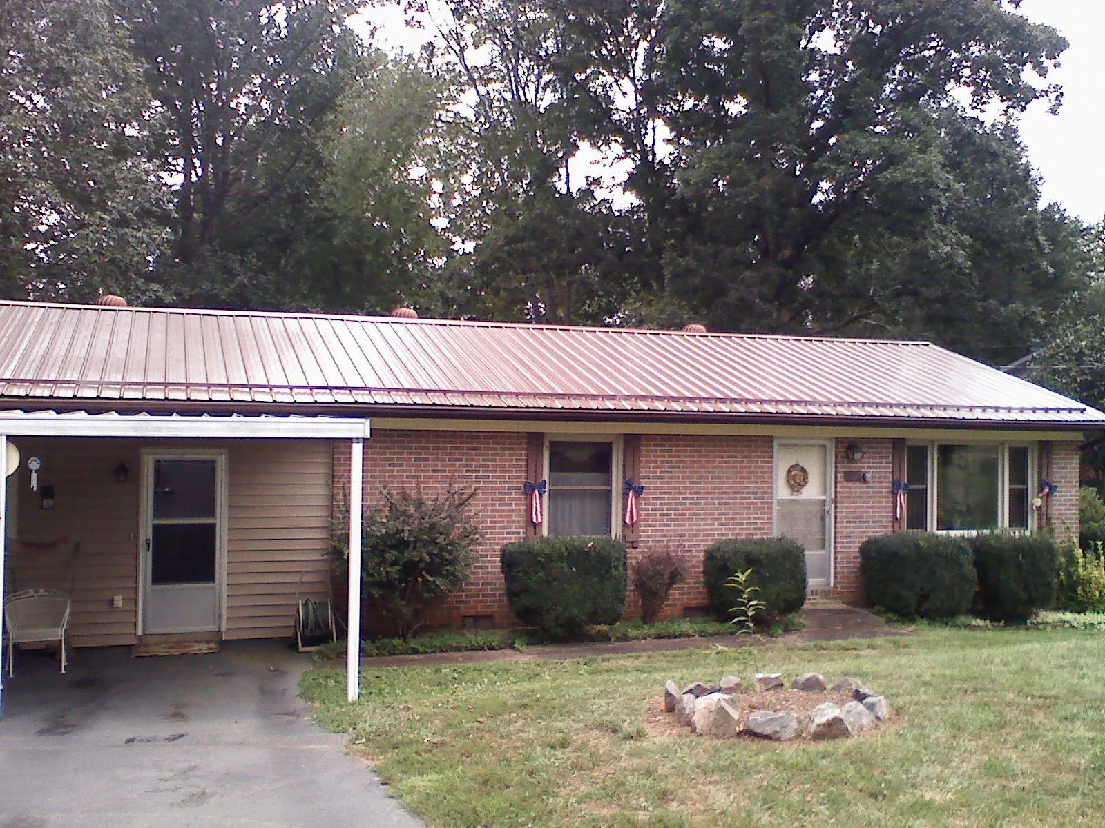 Bronze metal roof and carport on a brick ranch home — Roof Repair work by our crew in Stone Harbor