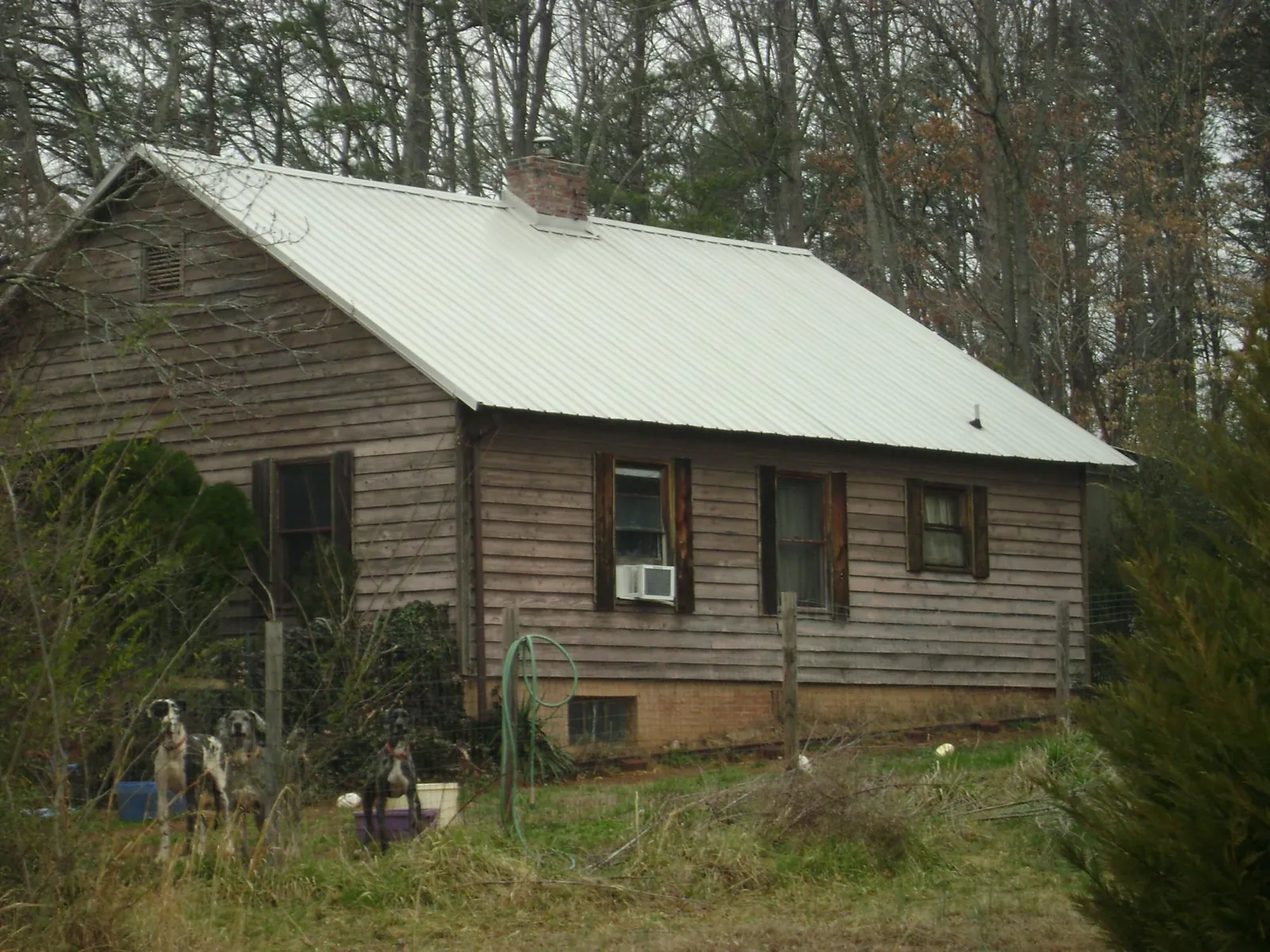 White metal roof on an old wood sided farmhouse, from a Metal Roof Installation job in Stone Harbor